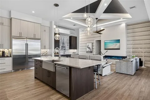 a kitchen with granite countertop a stove sink and cabinets