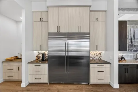 a kitchen with a dining table chairs sink and stove