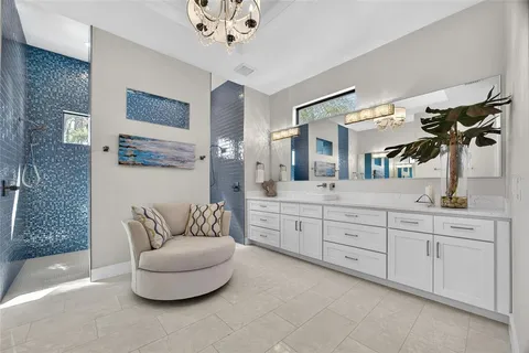 a living room with furniture and a painting on the wall