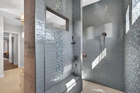 a bedroom with a bed and large windows