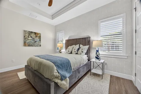 a close view of a stove a sink and dishwasher with white cabinets