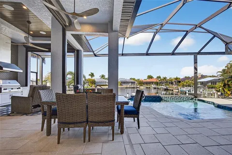 a kitchen with stainless steel appliances granite countertop a stove and white cabinets