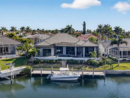 an aerial view of residential houses with outdoor space and parking