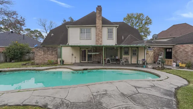 a front view of a house with swimming pool having outdoor seating