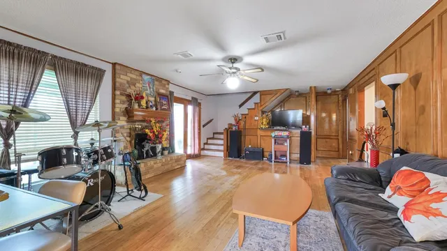 a living room with furniture and wooden floor