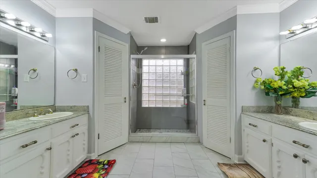 a spacious bathroom with a granite countertop sink a mirror a shower and a bathtub