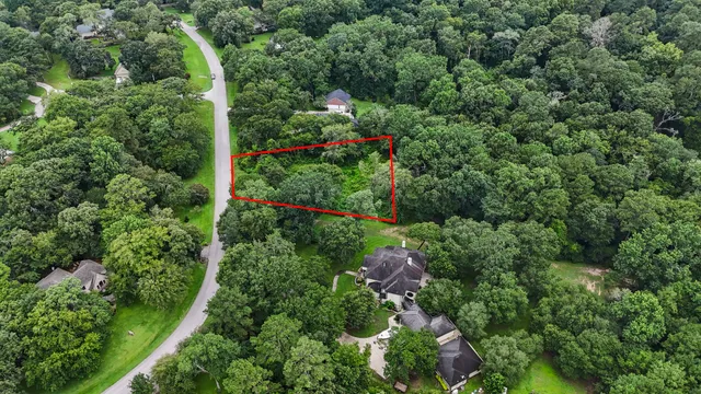 an aerial view of residential house with outdoor space and trees around