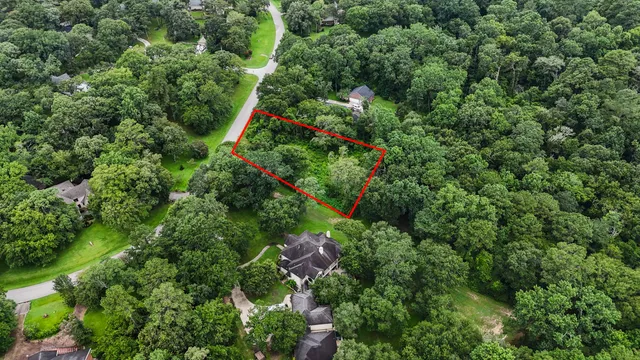 an aerial view of residential house with outdoor space and trees around
