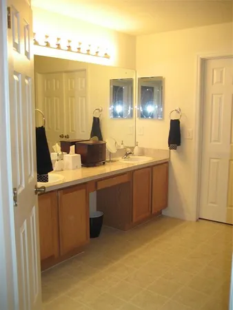 a bathroom with a double vanity sink and mirror