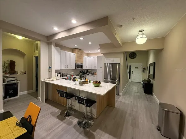 a kitchen with a sink appliances and cabinets