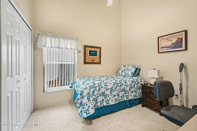 a bed room with a bed and a chair