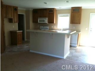 1400 Hall Road Mount Ulla, NC 28125 - Photo 2 of 13 a kitchen with kitchen island a sink appliances and cabinets