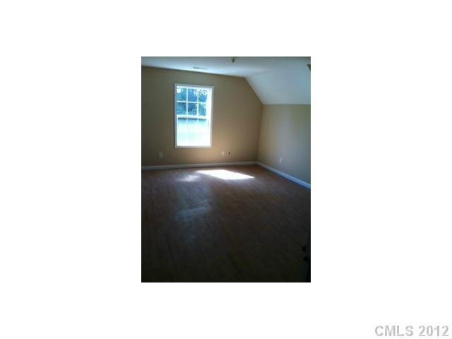 1400 Hall Road Mount Ulla, NC 28125 - Photo 11 of 13 a view of an empty room with wooden floor and a window