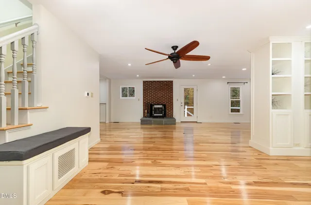 a living room with a fireplace and a floor to ceiling window