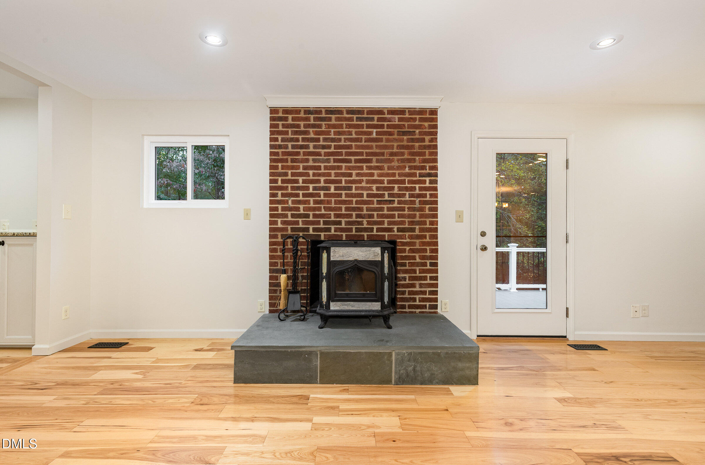 12413 Hardee Road Raleigh, NC 27614 - Photo 12 of 63 a living room with a fireplace and a floor to ceiling window