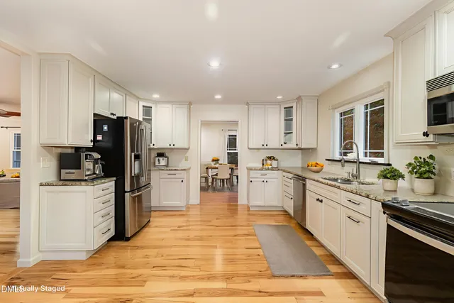 a kitchen with stainless steel appliances a refrigerator and wooden cabinets