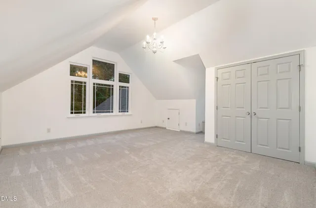 a view of a house with backyard and wooden fence