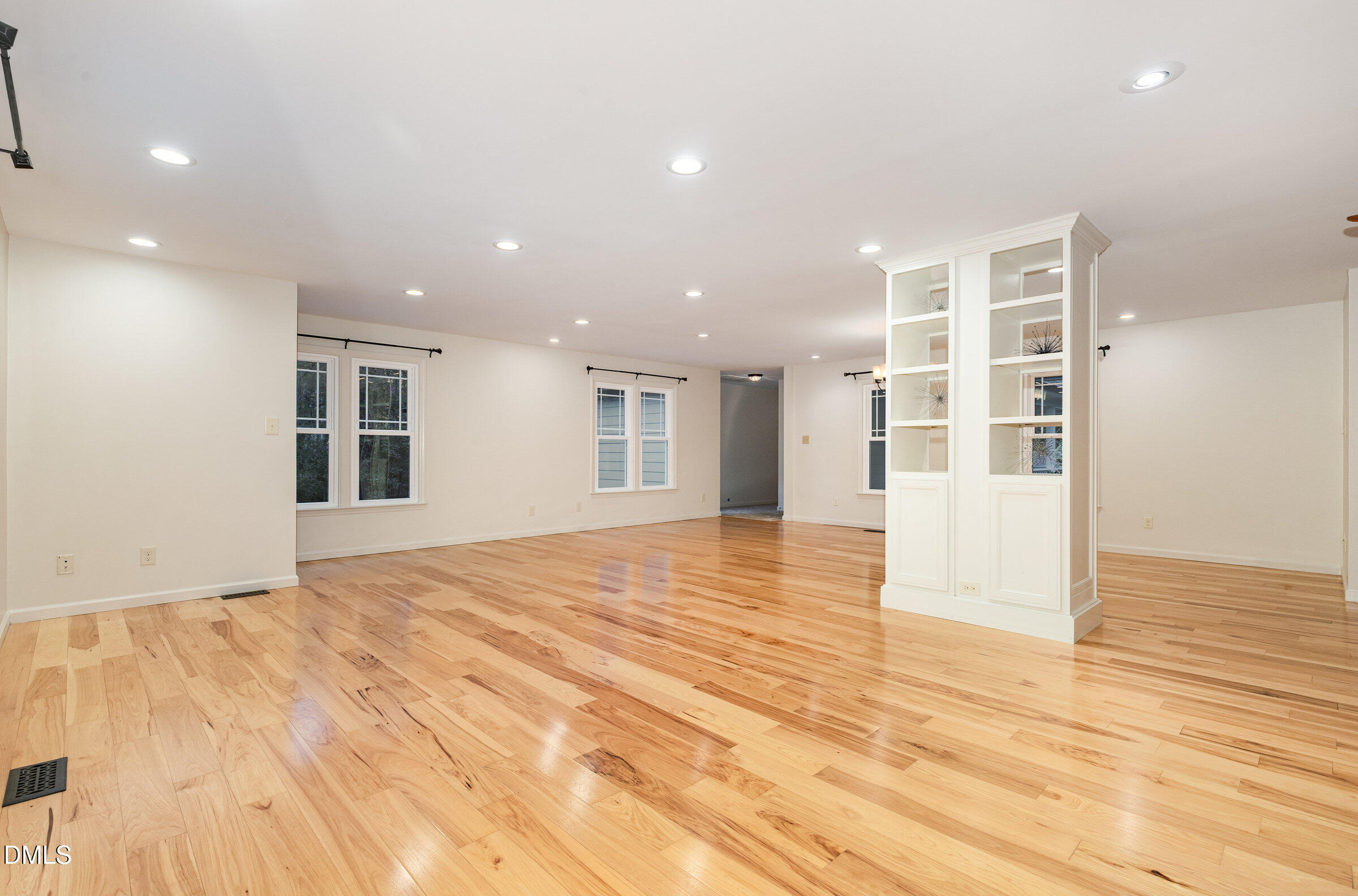 12413 Hardee Road Raleigh, NC 27614 - Photo 7 of 63 a view of an empty room with wooden floor and kitchen