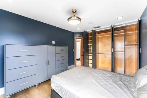 a bedroom with a bed and a dresser