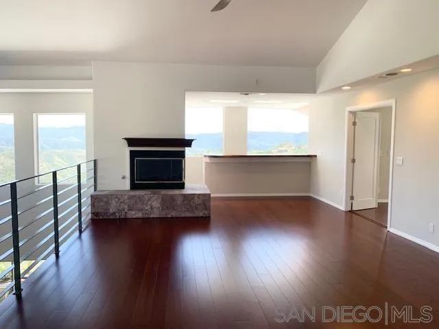 827 Mountain View Road El Cajon, CA 92021 - Photo 11 of 58 a living room with hard wood floors and a fireplace