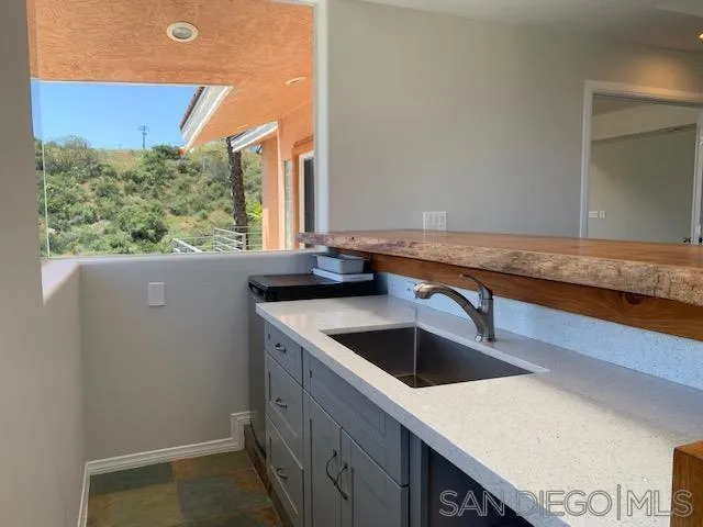 827 Mountain View Road El Cajon, CA 92021 - Photo 16 of 58 a kitchen with a sink and large window