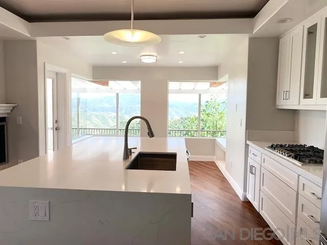 827 Mountain View Road El Cajon, CA 92021 - Photo 2 of 58 a kitchen with kitchen island a counter space a sink appliances and a large window