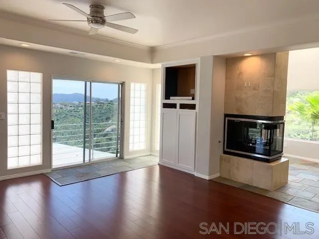 827 Mountain View Road El Cajon, CA 92021 - Photo 23 of 58 a view of a livingroom with wooden floor a ceiling fan and windows
