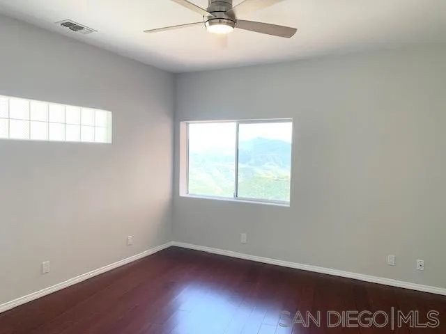 827 Mountain View Road El Cajon, CA 92021 - Photo 28 of 58 an empty room with a window and a ceiling fan
