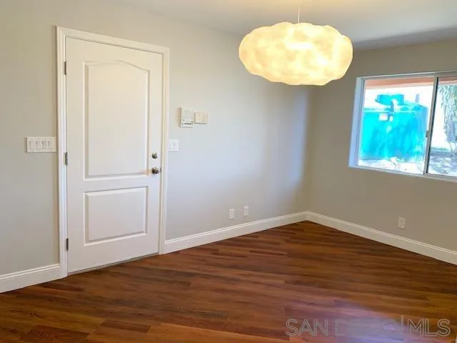 827 Mountain View Road El Cajon, CA 92021 - Photo 32 of 58 an empty room with wooden floor and windows