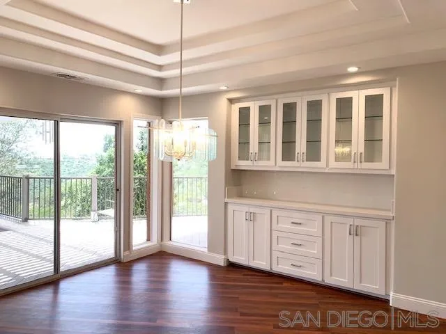 827 Mountain View Road El Cajon, CA 92021 - Photo 8 of 58 a view of an empty room with wooden floor and a window