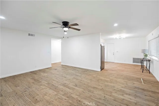 a view of a livingroom with a kitchen and a stove