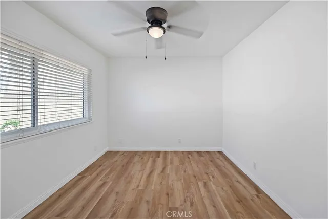 a view of room with hardwood floor and window