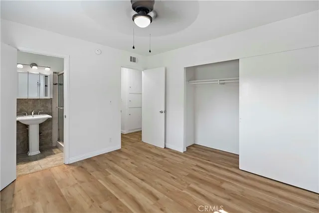 wooden floor in an empty room with a bathroom