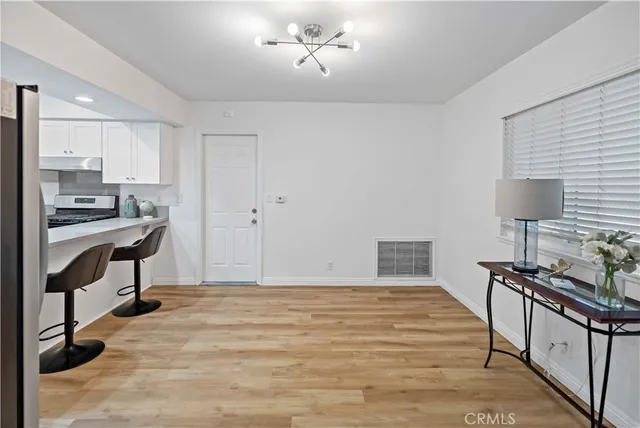 a bedroom with a bed and a lamp on table