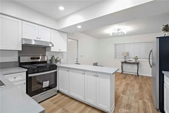 a kitchen with cabinets and stainless steel appliances