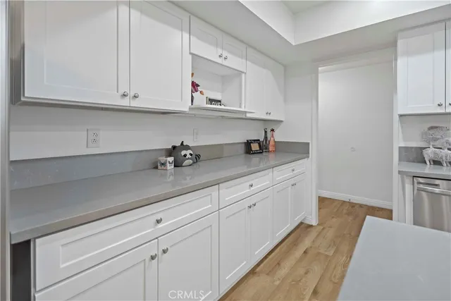 a kitchen with granite countertop white cabinets and white appliances