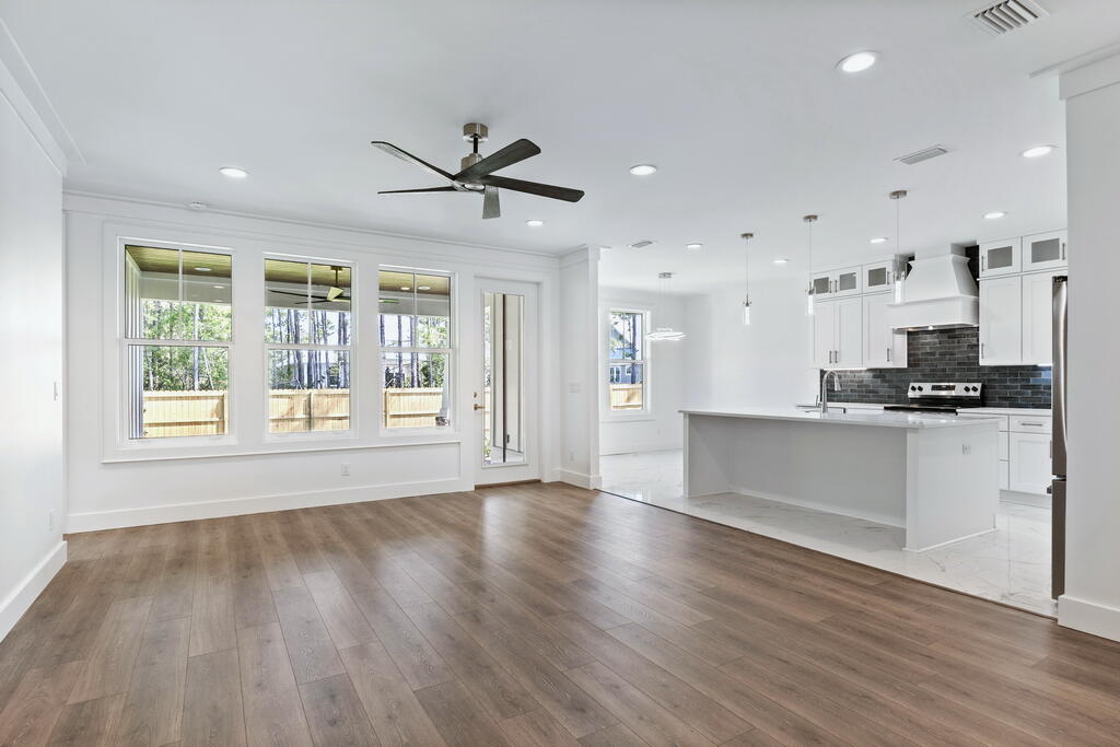 100 Grizzly Street Freeport, FL 32439 - Photo 11 of 65 a view of an empty room with wooden floor and a window