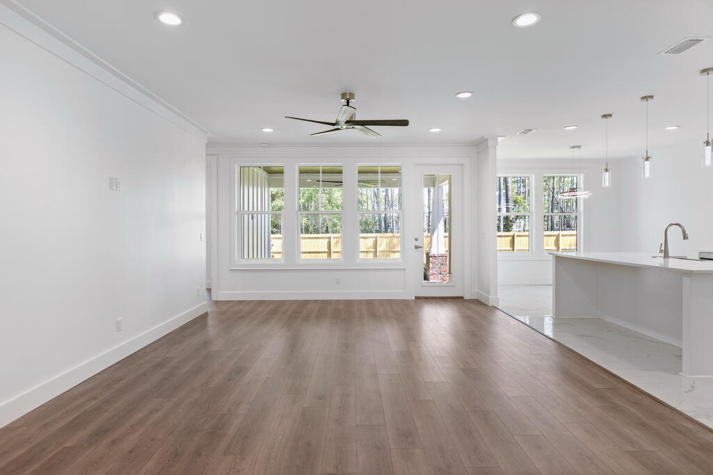 100 Grizzly Street Freeport, FL 32439 - Photo 16 of 65 an empty room with wooden floor and windows