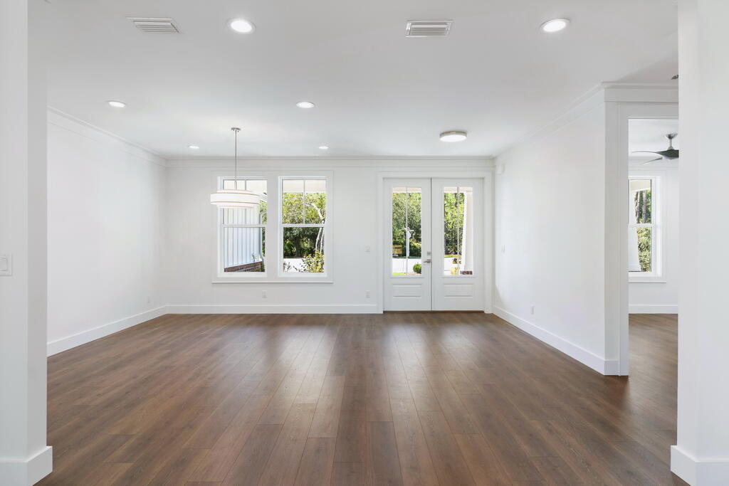 100 Grizzly Street Freeport, FL 32439 - Photo 18 of 65 an empty room with wooden floor and windows