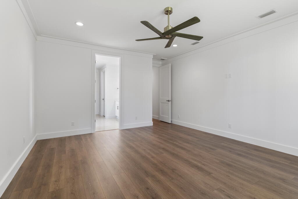 100 Grizzly Street Freeport, FL 32439 - Photo 21 of 65 an empty room with wooden floor and a ceiling fan