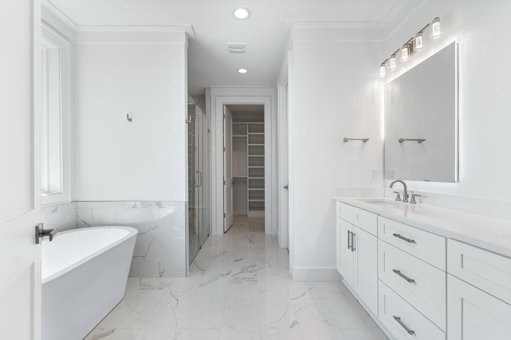100 Grizzly Street Freeport, FL 32439 - Photo 23 of 65 a spacious bathroom with a tub sink and mirror