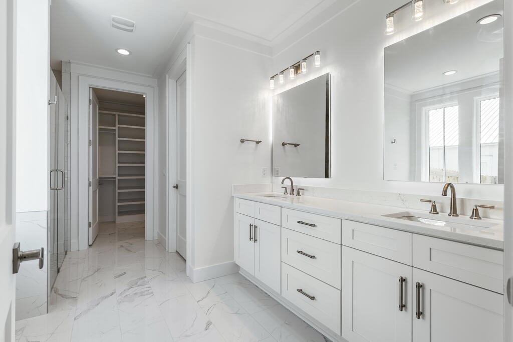 100 Grizzly Street Freeport, FL 32439 - Photo 24 of 65 a bathroom with double sink and a mirror