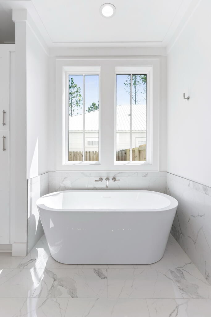 100 Grizzly Street Freeport, FL 32439 - Photo 29 of 65 a bath tub sitting in a bathroom next to a window