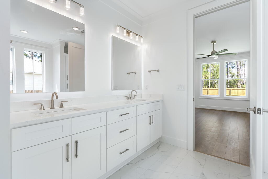 100 Grizzly Street Freeport, FL 32439 - Photo 31 of 65 a bathroom with double sink and a mirror