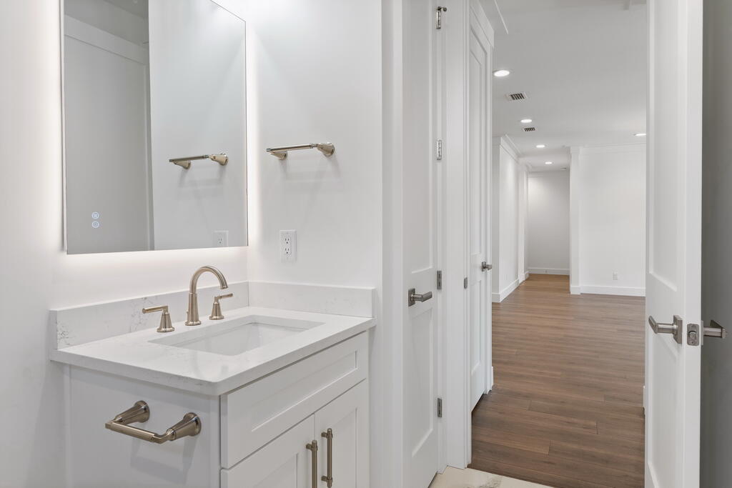 100 Grizzly Street Freeport, FL 32439 - Photo 38 of 65 a bathroom with a sink a mirror and a shower