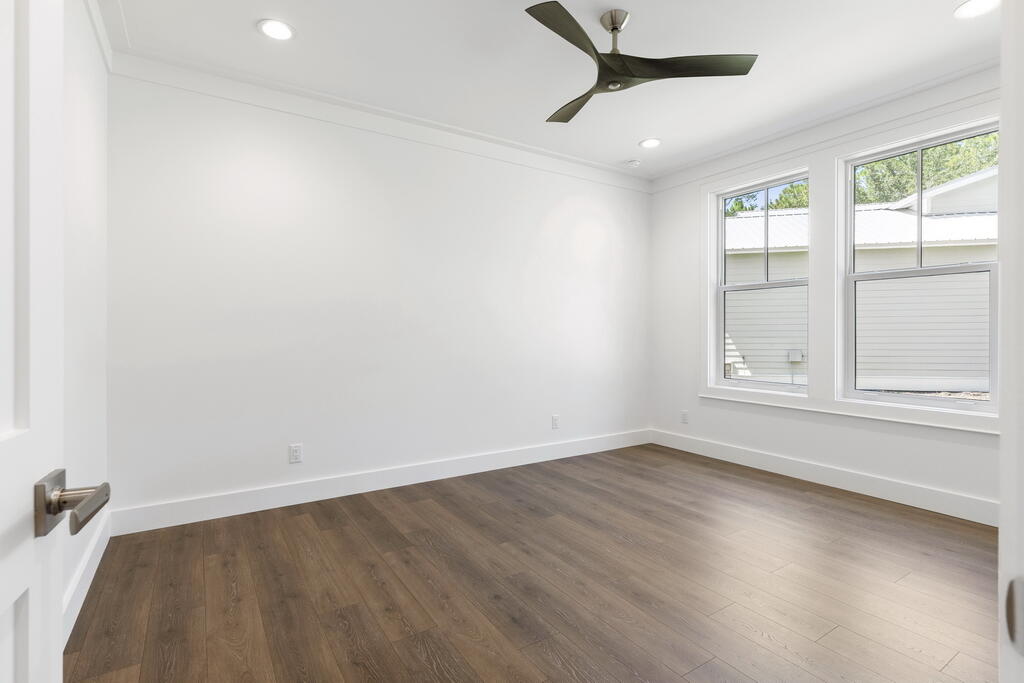 100 Grizzly Street Freeport, FL 32439 - Photo 39 of 65 an empty room with wooden floor and windows