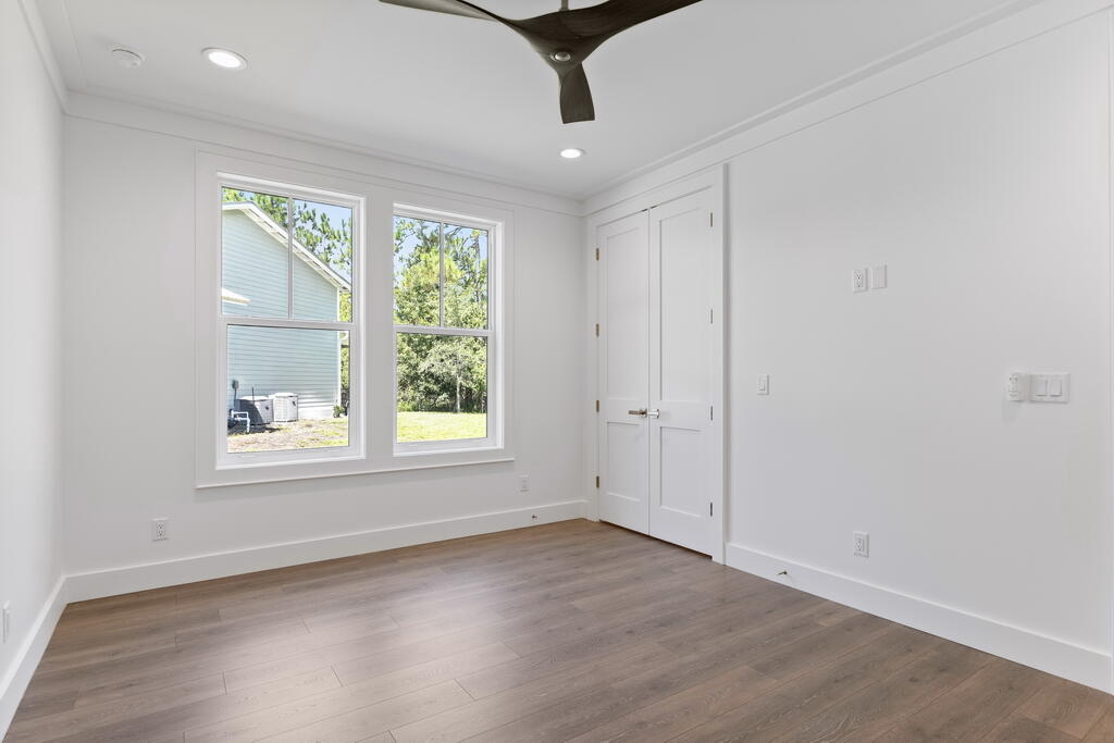 100 Grizzly Street Freeport, FL 32439 - Photo 40 of 65 an empty room with wooden floor and windows