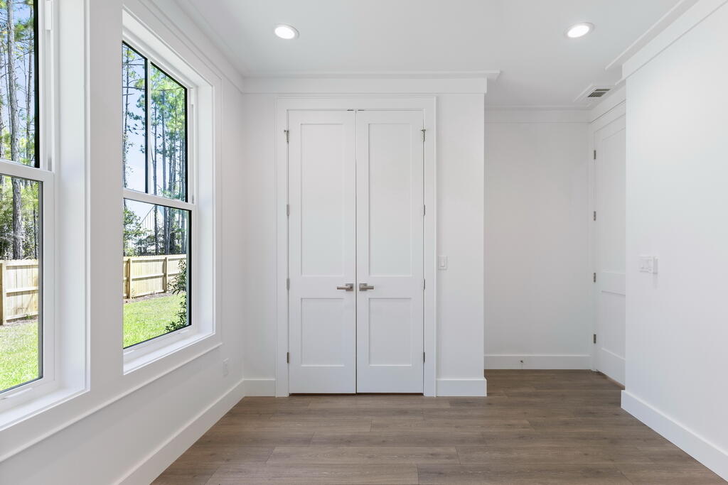 100 Grizzly Street Freeport, FL 32439 - Photo 43 of 65 a view of an empty room with wooden floor and a window