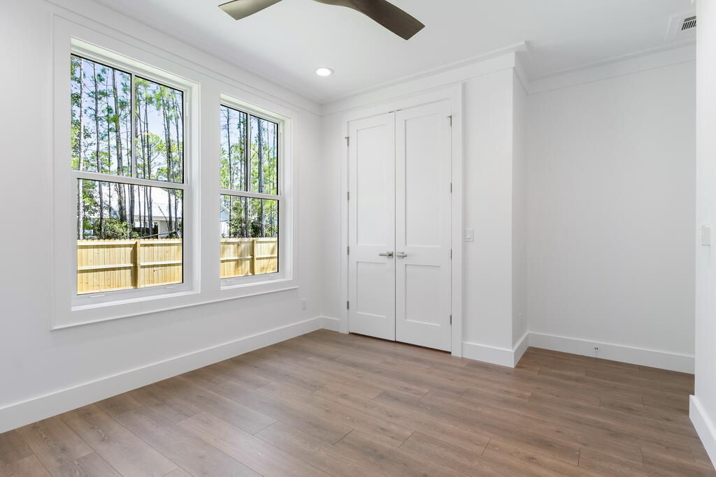 100 Grizzly Street Freeport, FL 32439 - Photo 44 of 65 a view of an empty room with wooden floor and a window