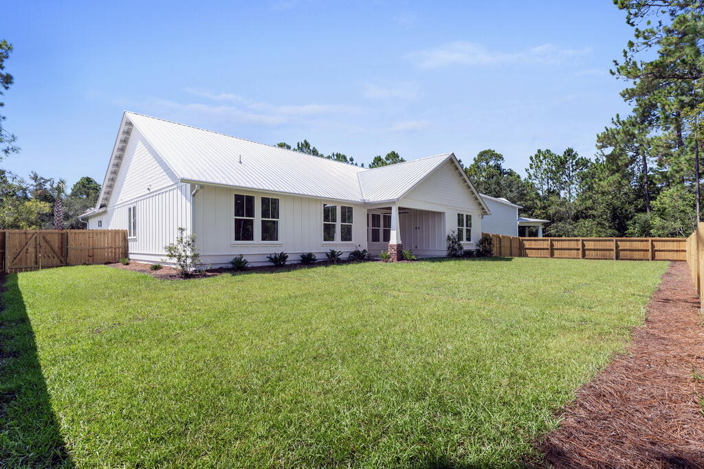 100 Grizzly Street Freeport, FL 32439 - Photo 50 of 65 a front view of house with yard outdoor seating and green space